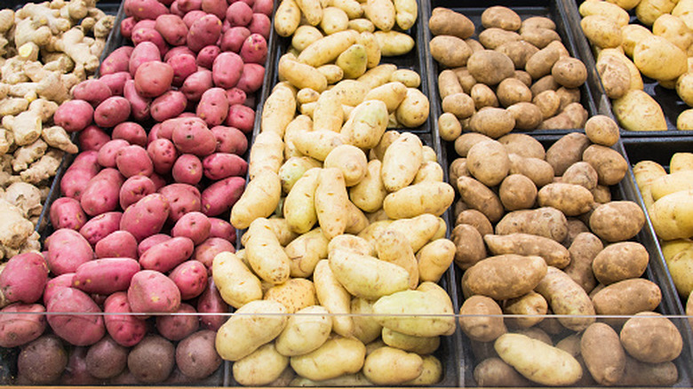 A variety of different potato types in a grocery store