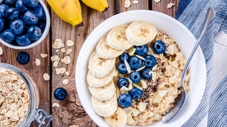 Oatmeal topped with blueberries, bananas, almonds, and seeds.