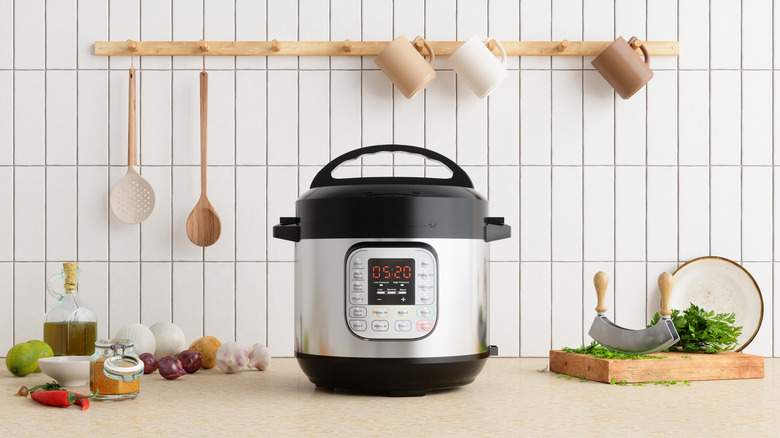 instant pot cooker on a counter with ingredients