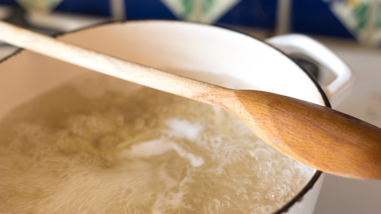 A Dutch oven filled with boiling water.