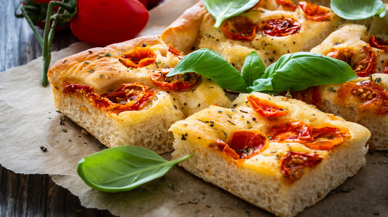Slices of tomato focaccia with basil.