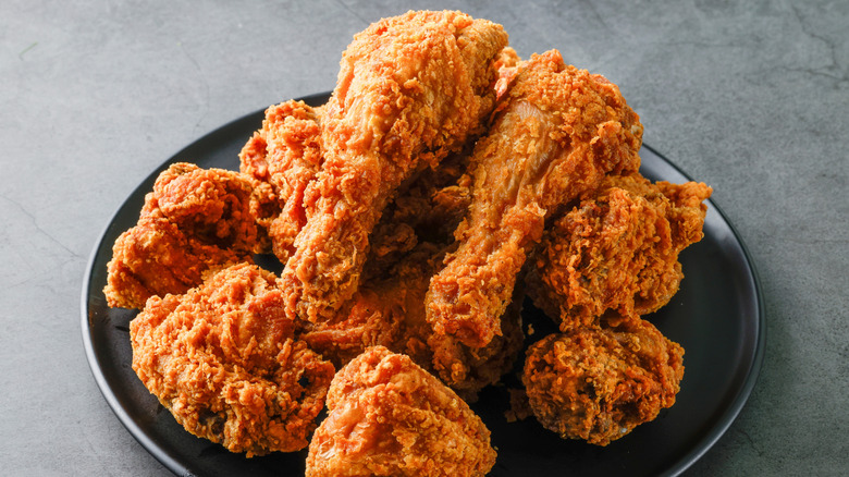 Black plate of crispy Korean fried chicken