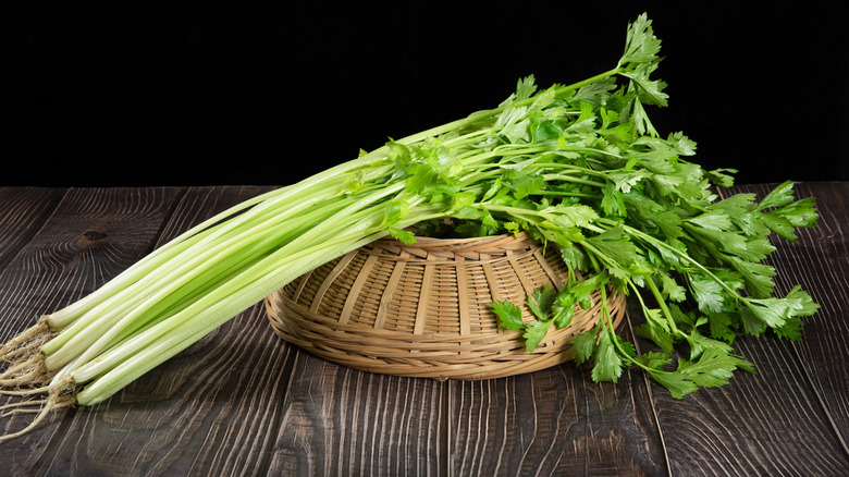 fresh celery with leaves on a wooden table