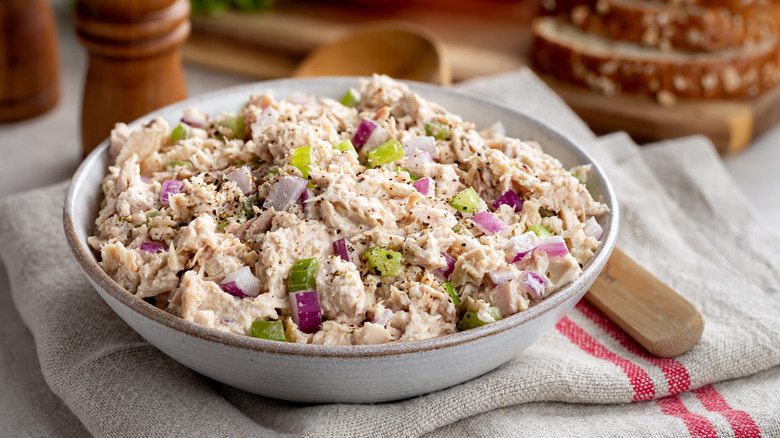 fresh tuna salad in a bowl with a wooden spoon