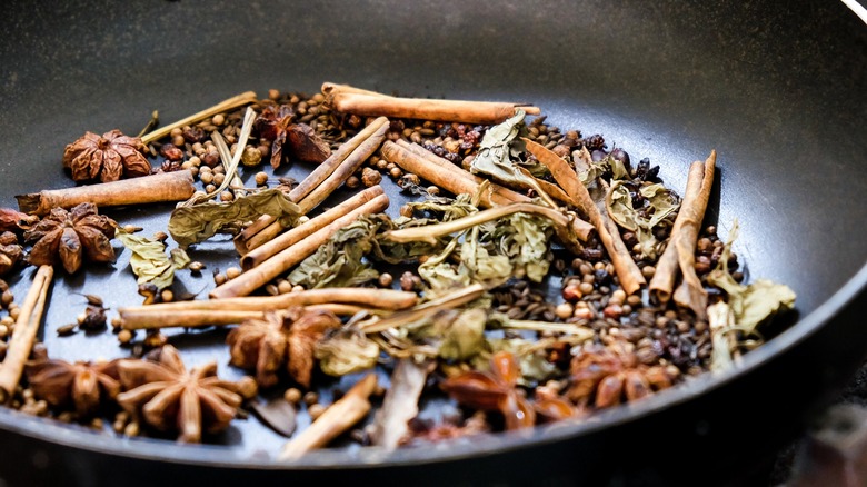 spices being toasted in a pan