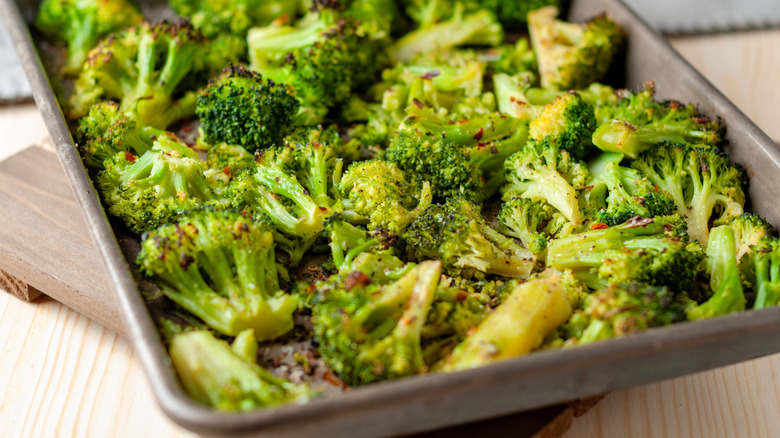 Vibrant green roasted broccoli on a sheet pan
