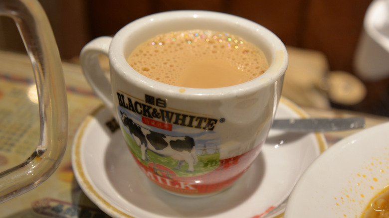 A cup of hot yuenyeung on a table.