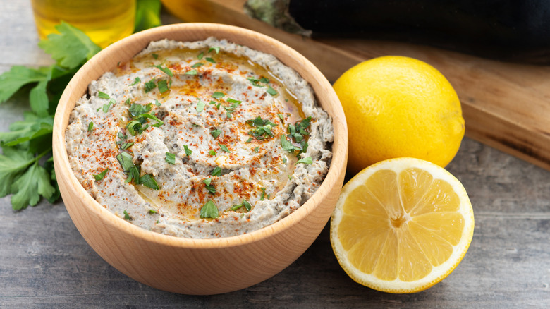 Bowl of baba ganoush and lemons