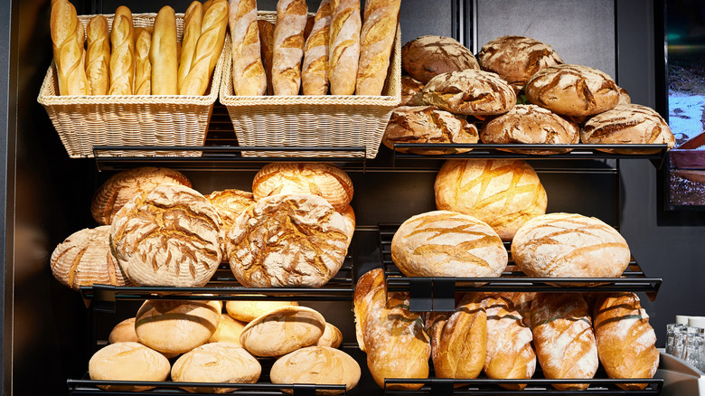 A bakery rack filled with different styles of bread