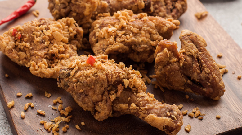 Fried chicken on a wooden plank