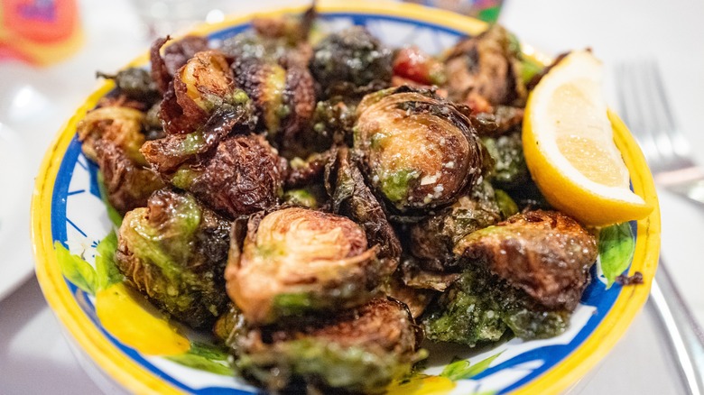 Roasted Brussels sprouts in a bowl with lemon