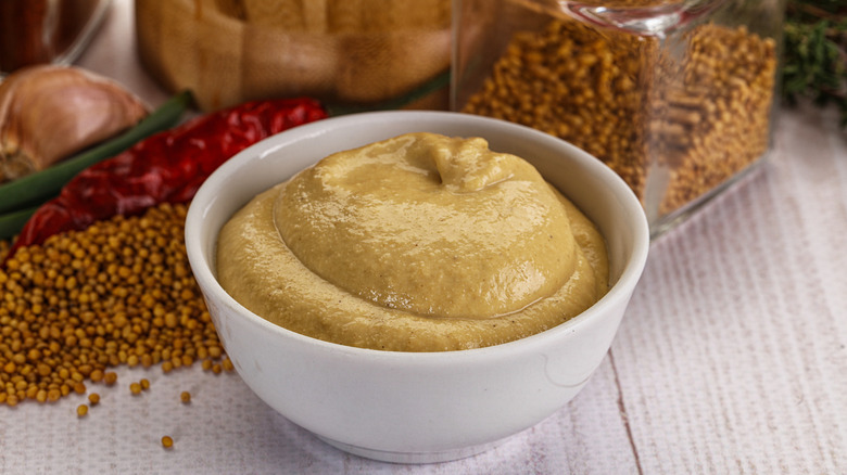 Bowl of Dijon mustard with other seasonings