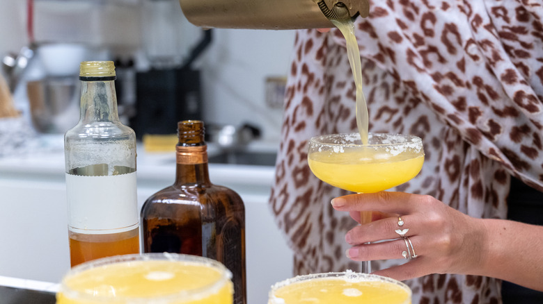 Person making margaritas as home