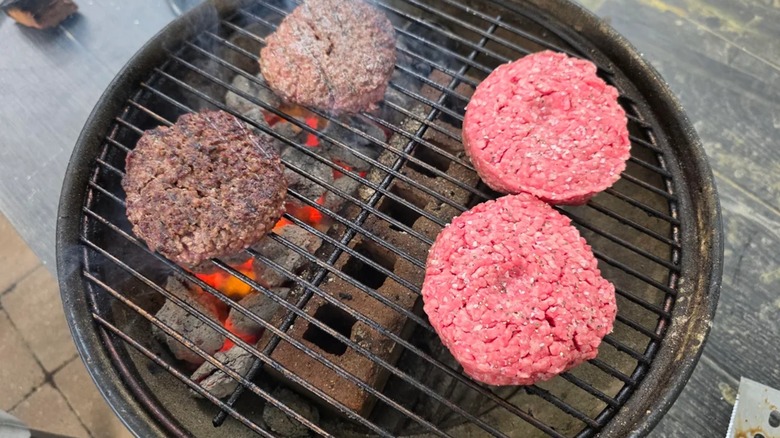 Two-zone burger cooking on a charcoal grill