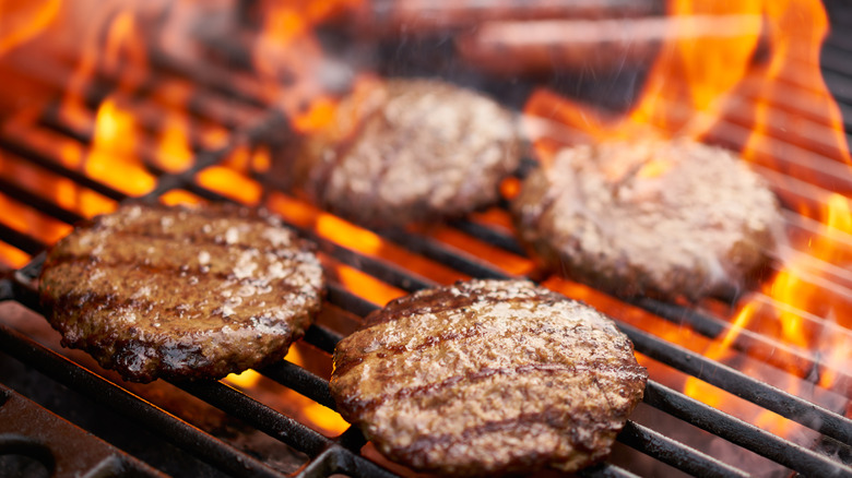 juicy burgers with crispy crusts on the grill