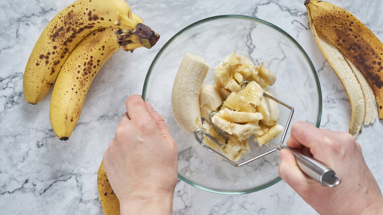 Bananas being mashed in a bowl
