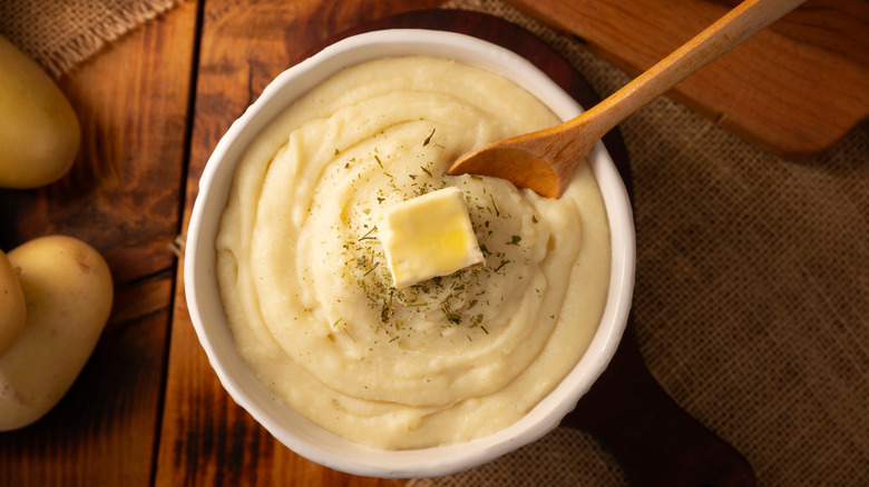 Bowl of mashed potatoes with butter on top