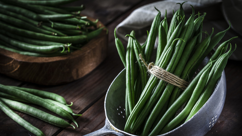 Fresh green beans in a metal colander