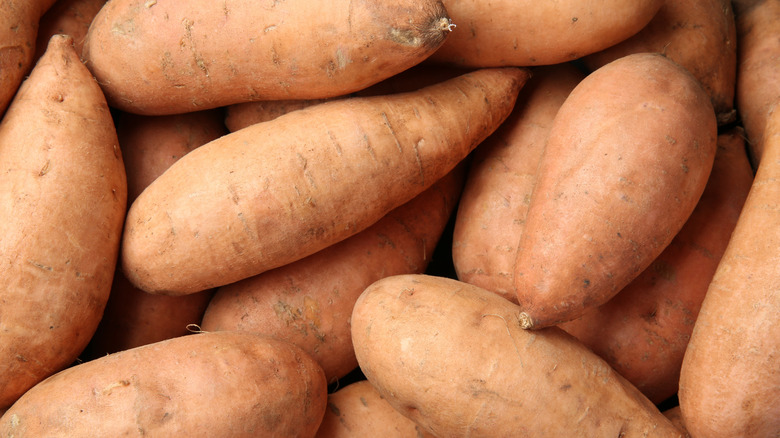 Raw sweet potatoes in a pile