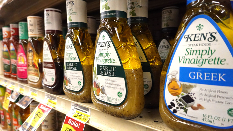 A row of salad dressing on a store shelf