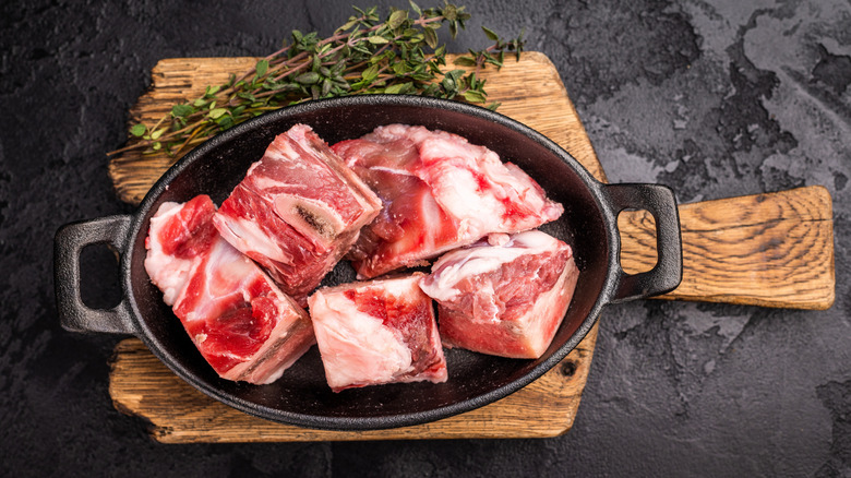 raw lamb meat in a cast iron skillet