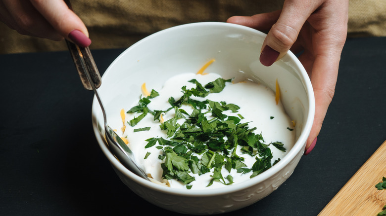 person making tartar sauce
