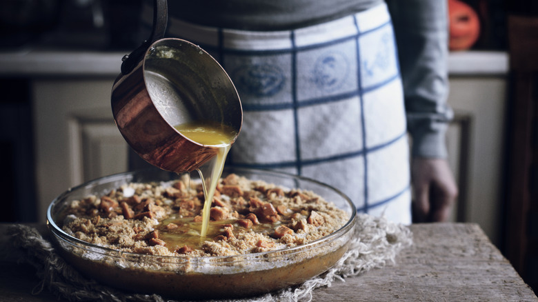 Butter being poured into a dump cake