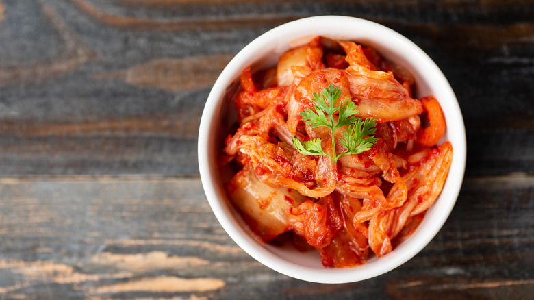 Bowl of kimchi on a wooden background