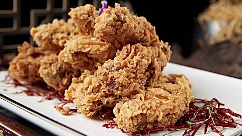 A close up of a plate of crispy fried chicken