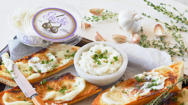 Trader Joe's garlic spread dip in the container, a small bowl, and on bread.