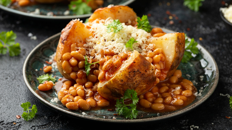 A jacket potato with beans and cheese on a plate