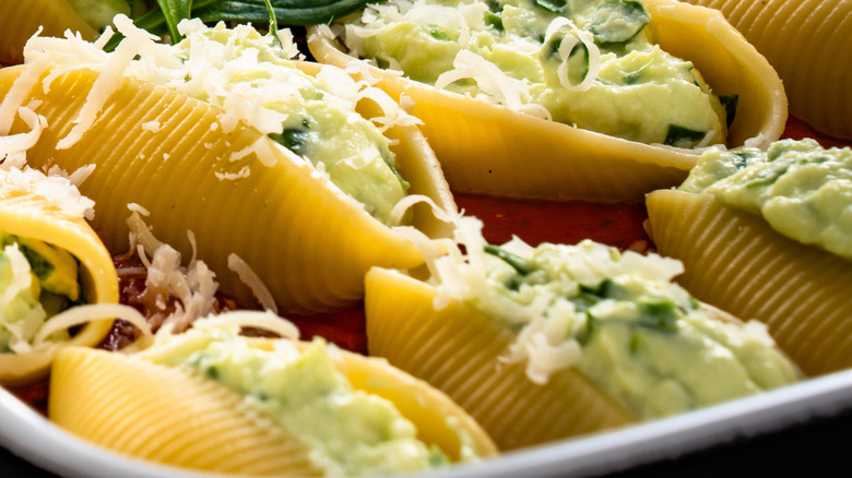 Close up of stuffed pasta shells with cheese and greens