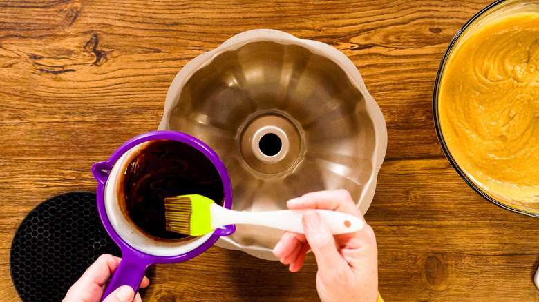 greasing a bundt pan with a basting brush