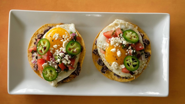 Two tostadas topped with ingredients