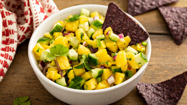 Pineapple and cucumber salsa with jalapeno and red onion served with chips