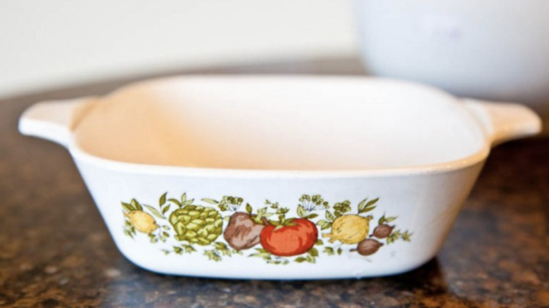 A CorningWare baking dish on a marble counter