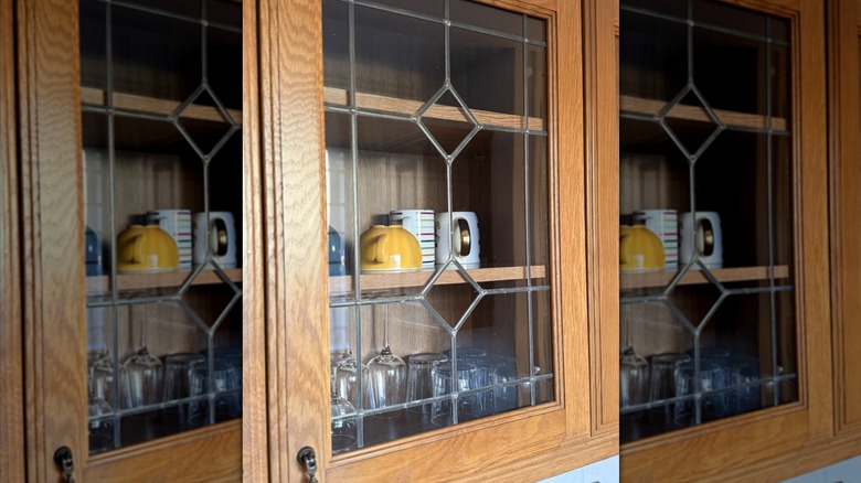 Glass-front cabinets with cups inside from the '90s