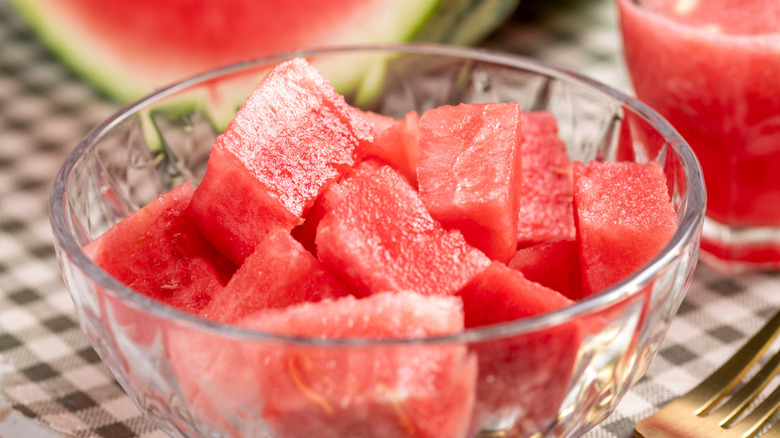 A bowl of watermelon cubes is photographed in close-up.