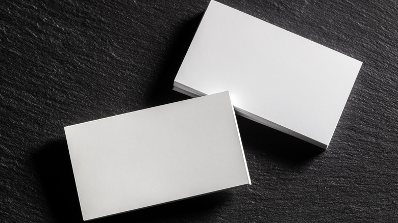 Plain white index cards on a black background.