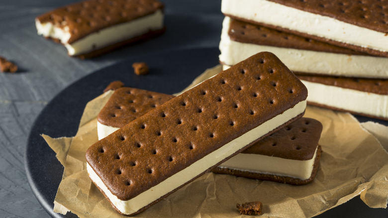 Classic ice cream sandwiches are stacked on a plate.