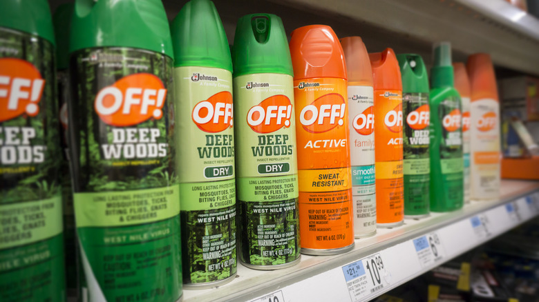 Several bug spray varieties on a store shelf.
