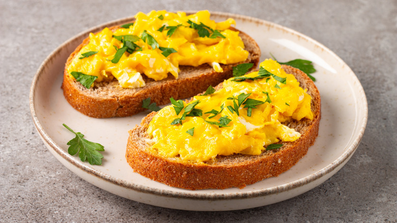 A lightly seasoned, openfaced scrambled egg sandwich