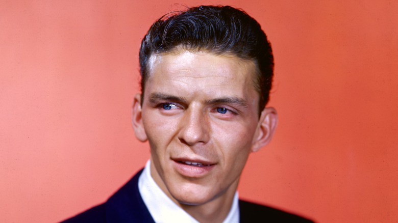 A young Frank Sinatra against a red background