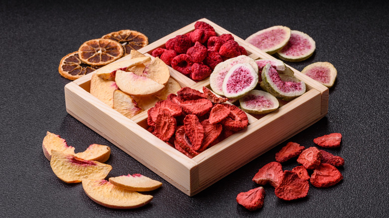 Box with compartments of freeze-dried raspberries, peach slices, strawberry slices, orange slices, and figs