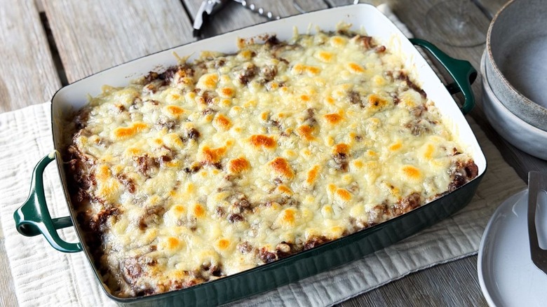 French onion chicken and rice casserole in serving dish on tabletop