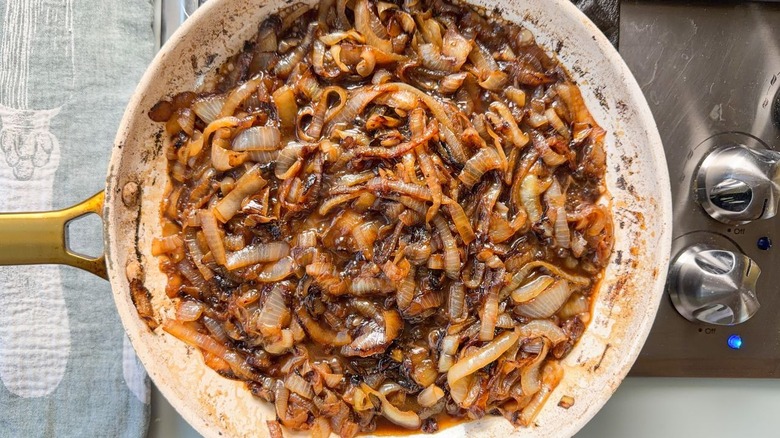 Caramelized onions with balsamic vinegar and wine in skillet on stovetop