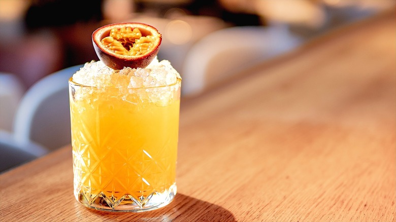 Passion fruit cocktail in short class with crushed ice and fresh fruit