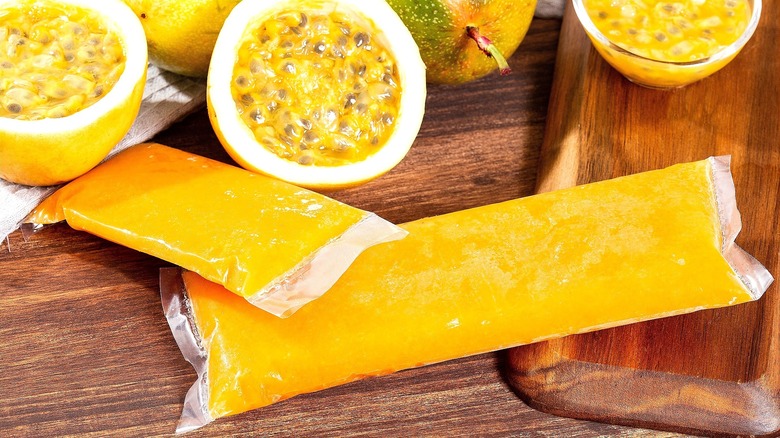 Fresh halved passion fruit and frozen packs of passion fruit pulp