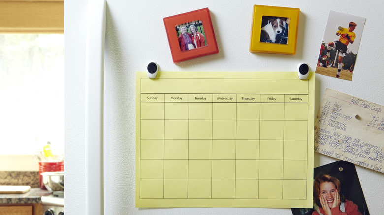 Photo of fridge door with many things on the door