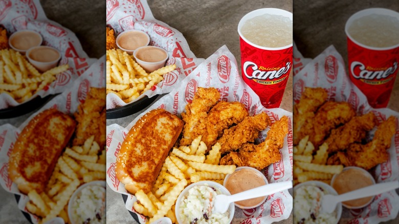 two Raising Cane's platters with fried chicken fingers, Texas Toast, coleslaw, and Cane's sauce with a drink